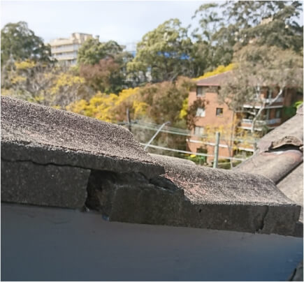 Broken brick roof on daytime with trees on the view