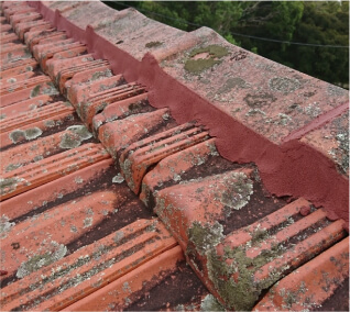 Photo of a roof in red with cracks and damages in it